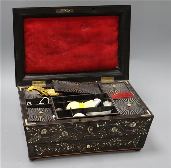 A 19th century, possibly Goanese, ebonised and ivory inlaid work box, with sectioned interior, and base drawer,